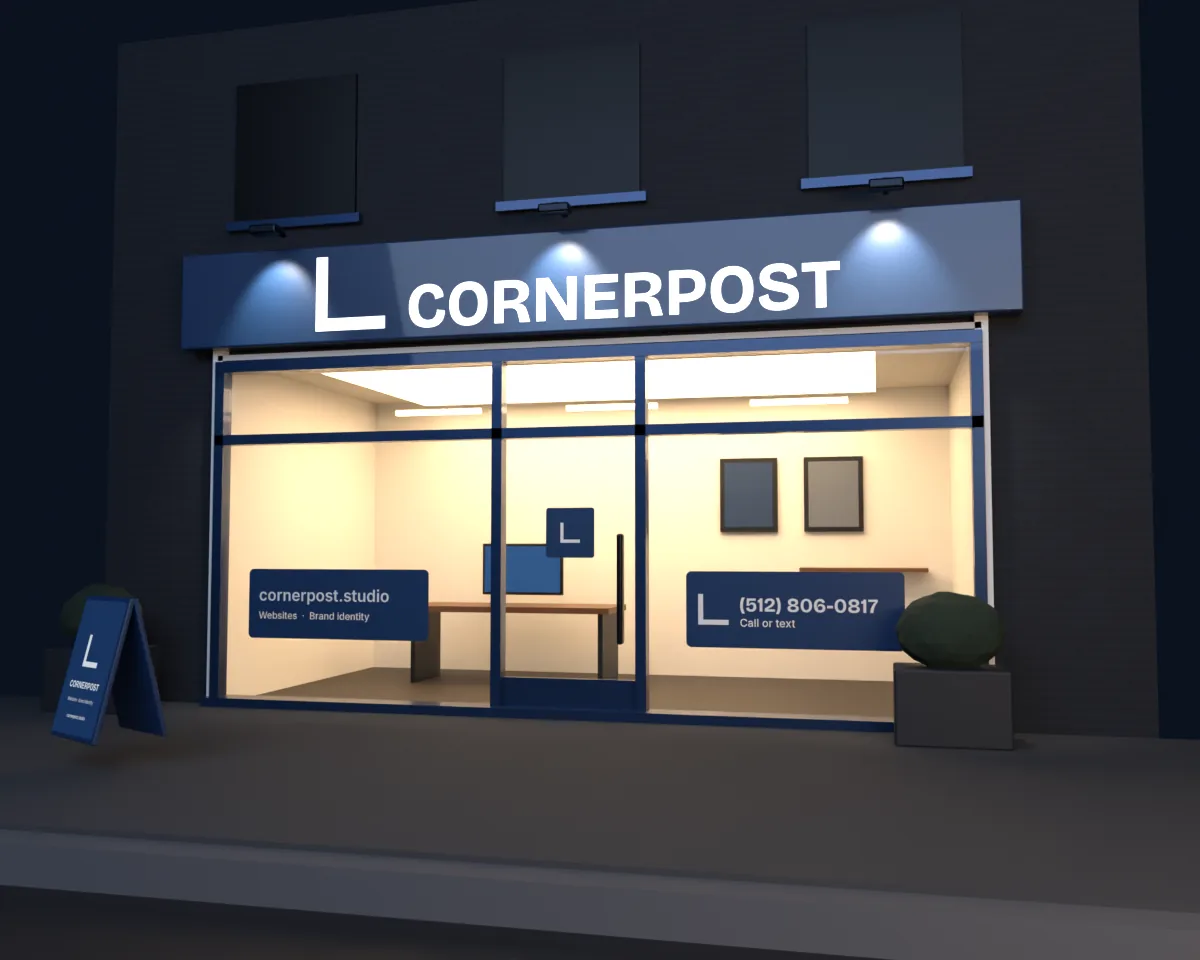 A storefront at dusk: a navy sign with lit CORNERPOST letters and the corner bracket over the windows, the website and phone number lettered on the glass, a warm studio inside.
